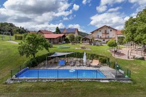 an aerial view of a swimming pool in a yard at 5 Sterne Holzchalet Dienberger Hof in Untergriesbach