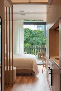 a bedroom with a bed and a balcony at v3rso Jardins in São Paulo +45 photos