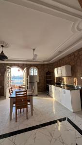 a kitchen with a table and chairs in a room at luxor nile palace in Luxor