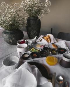 a table with a tray of food and a vase with flowers at CIRQA - Relais & Châteaux in Arequipa +57 photos