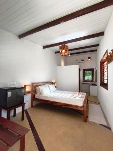 a bedroom with a bed and a tv in it at Villa Tarifa Suites in Amontada +48 photos