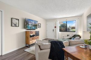 a living room with a couch and a table at Backyard Hideaway with King Bed, Garage, Bicycles in Loveland