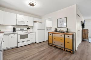 a kitchen with white cabinets and white appliances at Backyard Hideaway with King Bed, Garage, Bicycles in Loveland +21 photos