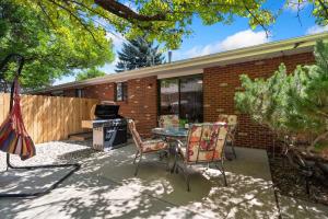 a patio with a table and chairs in front of a building at Backyard Hideaway with King Bed, Garage, Bicycles in Loveland