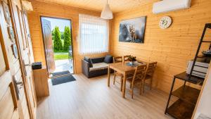 a living room with a table and a couch at Domki nad Soliną 665-189-444 OGRZEWANE in Solina