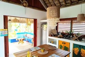 a kitchen with a table and a dining room at Mandala House - Kite Village in Icaraí