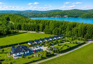 an aerial view of a large estate with a lake at Domki nad Soliną 665-189-444 OGRZEWANE in Solina