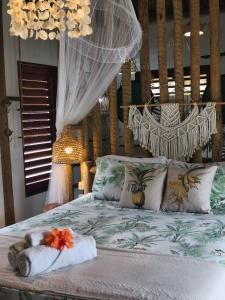 a bedroom with a bed with a hammock and towels at Mandala House - Kite Village in Icaraí