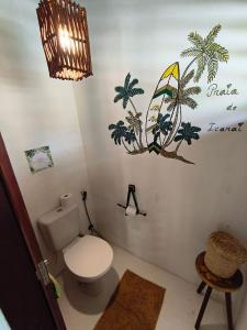 a bathroom with a toilet and palm trees on the wall at Mandala House - Kite Village in Icaraí +65 photos