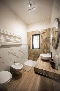 a bathroom with a sink and a toilet and a mirror at Agriturismo Fonte Belvedere in Collesalvetti +98 photos