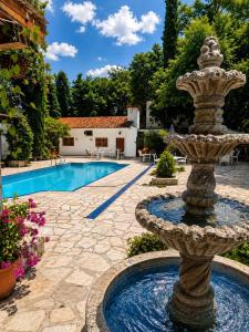 a fountain in a yard with a swimming pool at La Casita Inn Bustamante in Bustamante