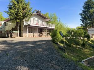 a house with a gravel driveway in front of it at Catskill Apartment, Little Love Bird #5 in Shandaken