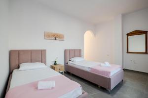 a bedroom with two beds and a mirror at Cloud Nine Retreat, Ksamil in Ksamil
