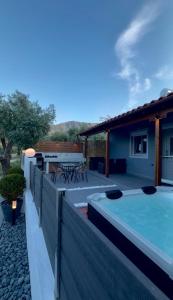 a backyard with a swimming pool and a house at Emerald Dream Oasis Studio in Skala Potamias