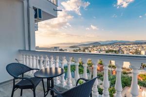 a balcony with chairs and a table and a view at Cloud Nine Retreat, Ksamil in Ksamil