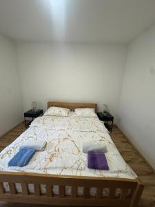 a bed with two pillows on it in a bedroom at Apartment Pantovic in Plužine