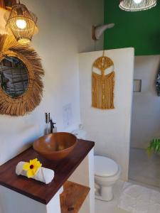 a bathroom with a wooden sink and a toilet at Green Coconut - Icaraí Kite Village in Icaraí