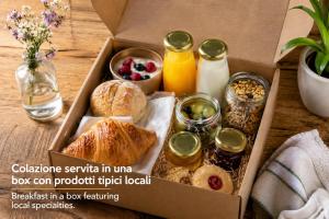 a box of food with pastries and other foods at Corte Tegassa Pool & Spa in Pinerolo