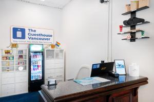 an office with a desk with a refrigerator at The Guesthouse Vancouver Downtown in Vancouver