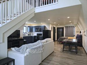 a living room and kitchen with a couch and a staircase at Observer Ranch Campground & Learning Center in Penrose