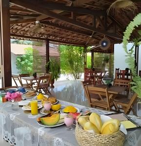 a table with plates of food on top of it at Villa of the Palm Trees in Icaraí