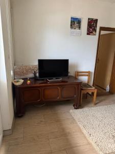 a television on a wooden table in a room at Apartment Pantovic in Plužine