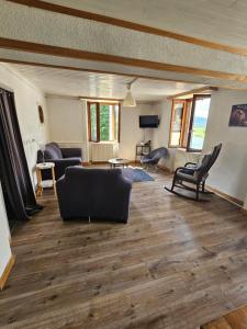 a living room with a couch and a table at relais de la diligence in Morteau