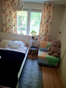 a small bedroom with a bed and a teddy bear at Chillroom in Rąbień