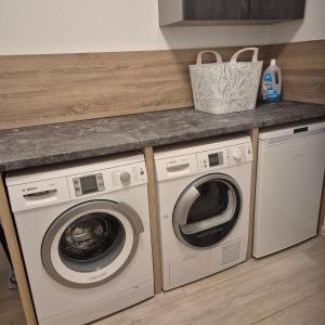 a kitchen with two washing machines and a counter at Landwiese in Landkern