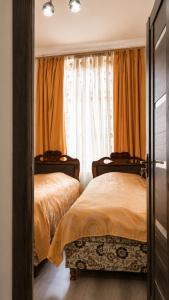 a bedroom with two beds and a window at Syune House in Tatʼev
