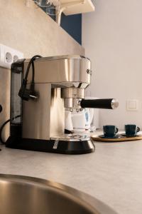 a coffee maker on a counter in a kitchen at Apartman Spa Bačka in Bačka Palanka