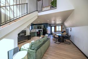 an open living room with a couch and a table at Observer Ranch Campground & Learning Center in Penrose