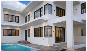 a house with a swimming pool in front of it at D'eaU BleU Villa-Private pool in Pereybere