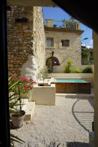 a house with a swimming pool and plants in front of it at Le Loft in Sainte Anastasie - Aubarne