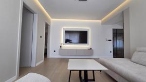 a living room with a couch and a tv at Apartman Premium Posušje in Posušje