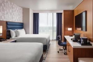 a hotel room with two beds and a desk at Hollywood Casino & Hotel Columbus in Columbus +5 photos