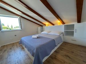 a bedroom with a bed and a window at Blue Wave Apartments - Adriatic in Slano