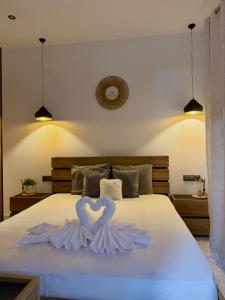 a bed with a heart made out of towels at Emerald Dream Oasis Studio in Skala Potamias +12 photos