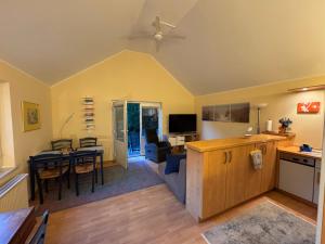 a living room with a kitchen and a dining room at Ferienhaus Loubier Marne in Marne