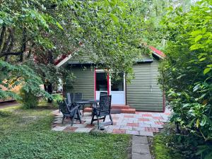 a patio with a table and chairs in front of a house at Ferienhaus Loubier Marne in Marne