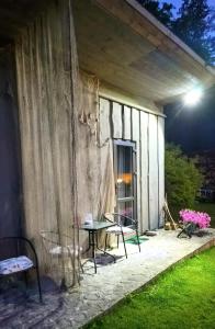 a patio at night with a table and chairs at Imantass in Salacgrīva +9 photos
