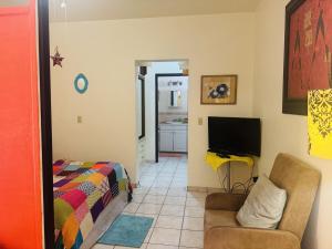 a living room with a couch and a television at Ocean Light at Villa Hermosa in San Carlos