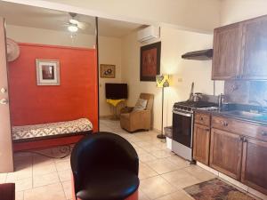 a kitchen with a chair and a couch in a room at Ocean Light at Villa Hermosa in San Carlos