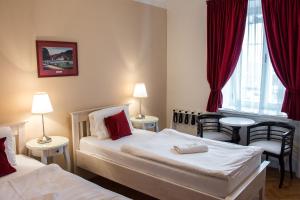 a hotel room with two beds and a window at Pivovar Hotel Na Rychtě in Ústí nad Labem