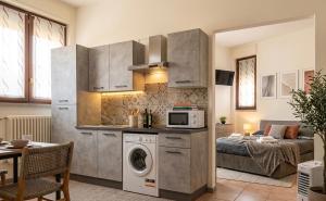a kitchen with a washing machine in a room at Jessy house in Cantù
