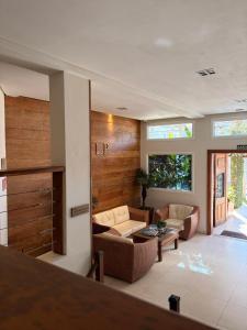 a living room with two couches and a table at Juquehy La Plage Hotel in Juquei