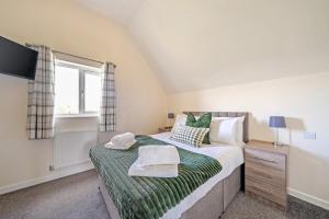 a bedroom with a bed and a window at Sage Lodge in Brigg