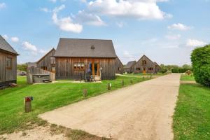 a dirt road in front of a barn at Sage Lodge in Brigg