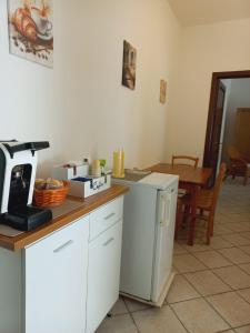 a kitchen with white cabinets and a counter top at IL MELOGRANO Rooms in Vignacastrisi