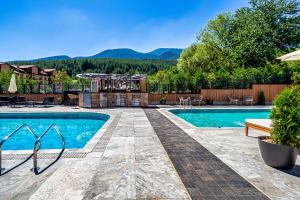 a swimming pool in a yard with a house at Premier Luxury Mountain Resort in Bansko +123 photos